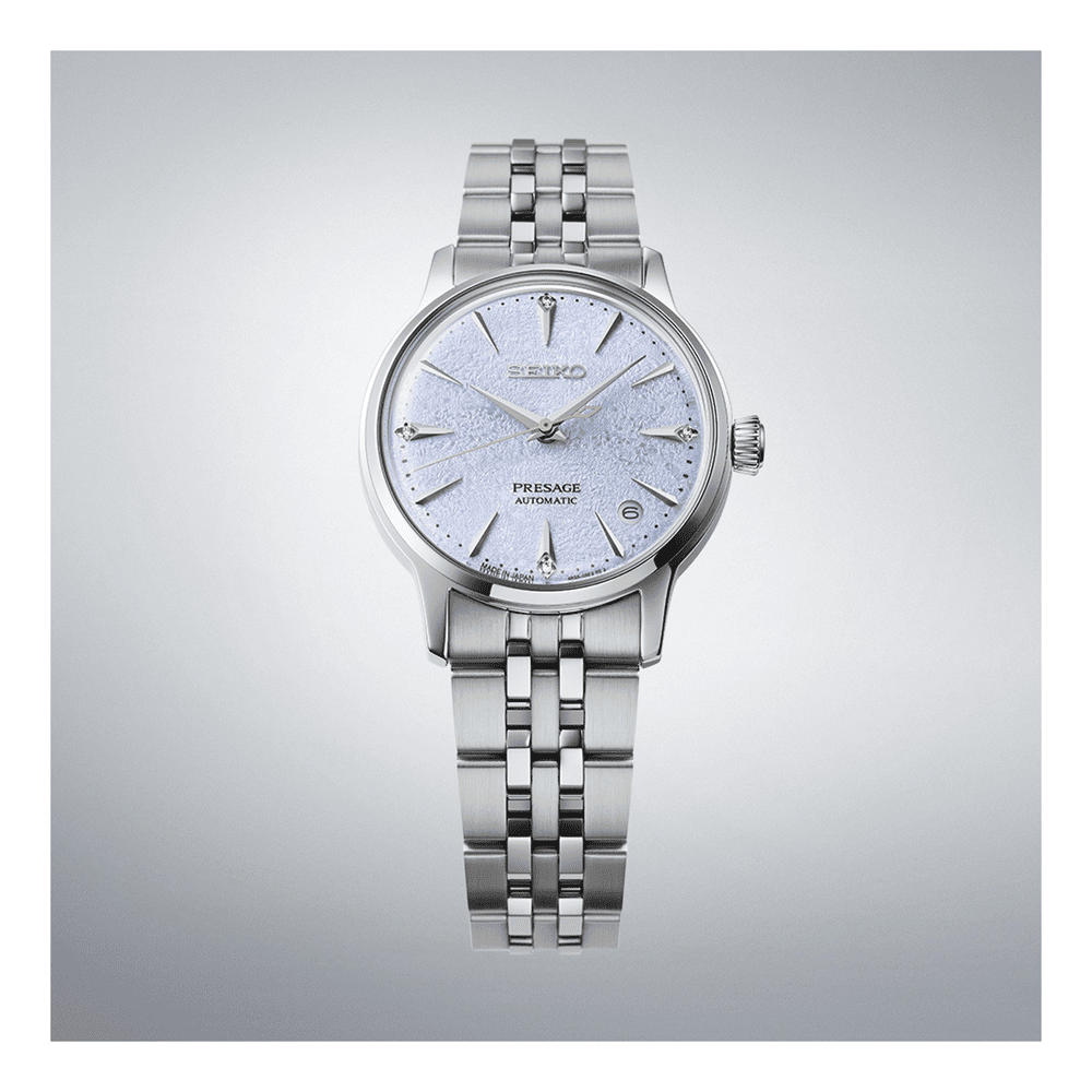 Silver Seiko watch with a light blue face on a gray background
