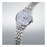 Silver wristwatch with a detailed face on a light gray background